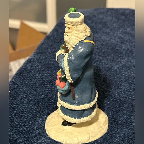 Blue robed Santa with green mittens holds a doll & basket of fruit. - Picture 2 of 7